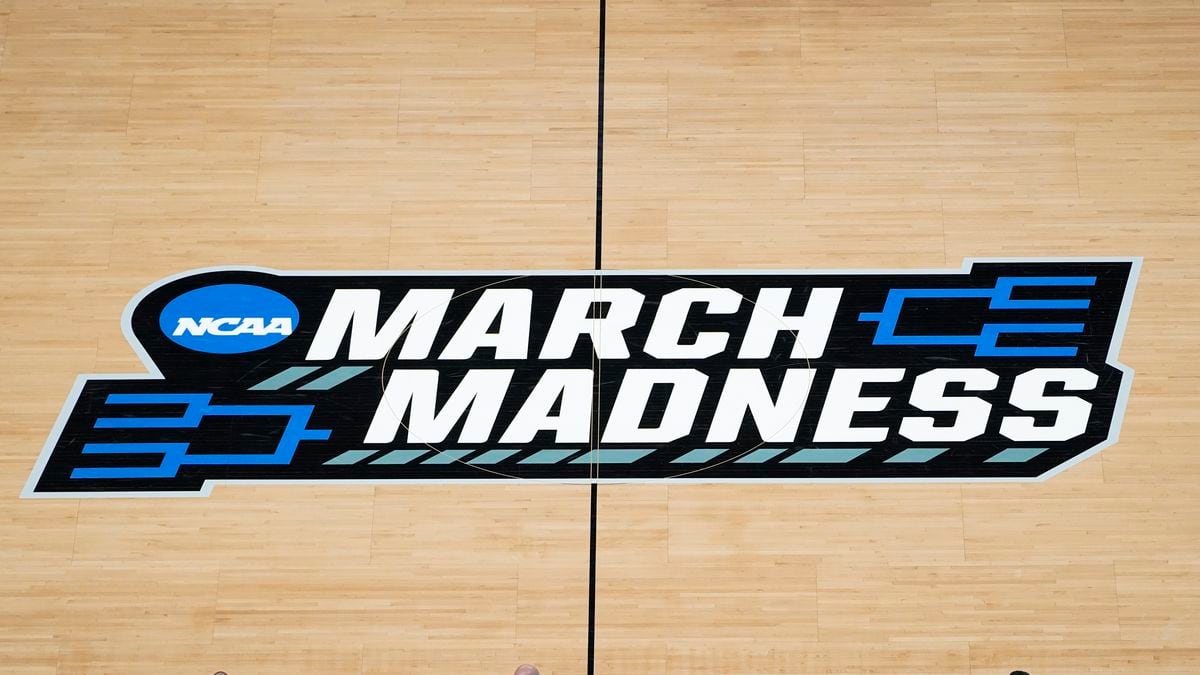 The March Madness logo is shown on the court during the first half of a men's college...