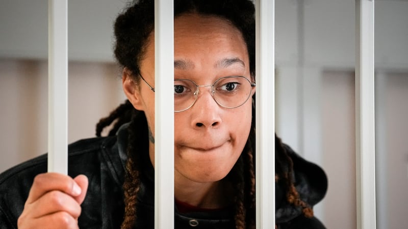 WNBA star and two-time Olympic gold medalist Brittney Griner speaks to her lawyers standing in...