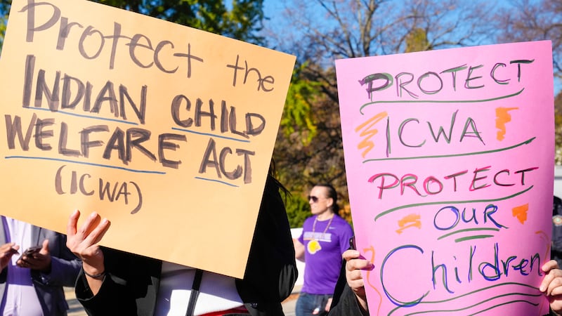 FILE - Demonstrators stand outside the U.S. Supreme Court in Washington, Nov. 9, 2022, as the...