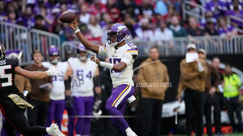 Minnesota Vikings quarterback Joshua Dobbs looks to throw a pass during the second half of an...