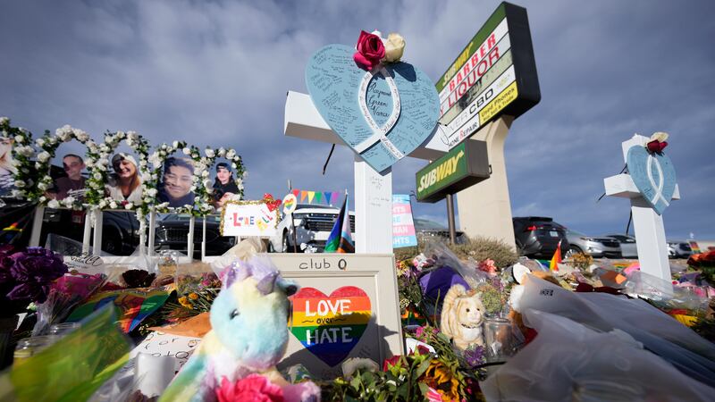 Crosses for the victims stand as part of a makeshift memorial near the scene of a mass...