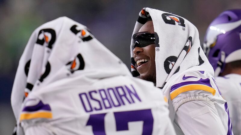 Minnesota Vikings wide receivers K.J. Osborn (17) and Justin Jefferson stand on the sideline...
